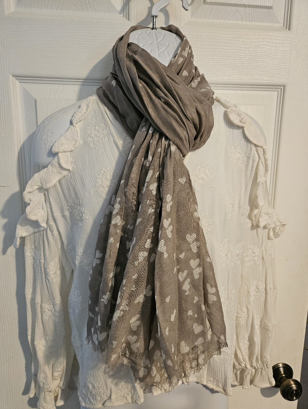 Woman's light gray scarf with white hearts